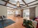 Bright living room features wood floors, beamed ceilings and sliding barn doors at 606 Howell Ave, Brooksville, FL 34601