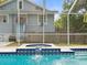 A screened in pool includes an integrated spa, and patio waterfall at 606 Howell Ave, Brooksville, FL 34601