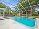Enclosed pool with attached spa and -safe red storage shed at 606 Howell Ave, Brooksville, FL 34601