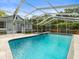 A screened in pool and a spa is beside the home at 606 Howell Ave, Brooksville, FL 34601