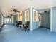 Spacious covered porch with blue flooring and ceiling fans provides a relaxing outdoor living space at 606 Howell Ave, Brooksville, FL 34601