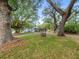 Charming home surrounded by mature trees and landscaping, complemented by a classic water well feature at 606 Howell Ave, Brooksville, FL 34601