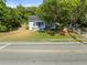 A view of home with large front yard and mature tree at 606 Howell Ave, Brooksville, FL 34601