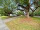 Charming home nestled between mature trees, complemented by a well-maintained lawn and landscaping at 606 Howell Ave, Brooksville, FL 34601