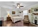 Inviting bedroom featuring hardwood floors, a ceiling fan, and a comfortable reading chair at 6219 Wilds Dr # 11A, New Port Richey, FL 34653
