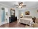 Comfortable bedroom with an ensuite bathroom, hardwood floors, and a ceiling fan at 6219 Wilds Dr # 11A, New Port Richey, FL 34653