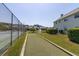Bocce ball court beside a tennis court with a water fountain and lush community landscaping at 6219 Wilds Dr # 11A, New Port Richey, FL 34653
