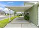 Home features a carport for covered parking with a green exterior, easy access, and well-maintained landscaping at 6219 Wilds Dr # 11A, New Port Richey, FL 34653