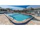 Relaxing community pool with clear blue water, shaded seating, and well-maintained patio area at 6219 Wilds Dr # 11A, New Port Richey, FL 34653