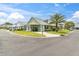 Charming home with lush landscaping, mature palm trees, neutral color palette, and cozy carport entrance at 6219 Wilds Dr # 11A, New Port Richey, FL 34653
