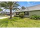 Charming home with a well-manicured lawn, mature landscaping, and a vibrant green exterior at 6219 Wilds Dr # 11A, New Port Richey, FL 34653