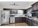 Modern kitchen features stainless steel appliances, granite counters, and dark cabinetry at 6219 Wilds Dr # 11A, New Port Richey, FL 34653