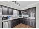 Updated kitchen featuring stainless appliances and stylish dark wood cabinets at 6219 Wilds Dr # 11A, New Port Richey, FL 34653