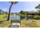 Scenic pond view with fountain, palm trees, serene landscaping, and relaxing bench seating at 6219 Wilds Dr # 11A, New Port Richey, FL 34653
