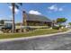 The Wilds Recreation Center with inviting landscaping, brick details, and ample parking on a sunny day at 6219 Wilds Dr # 11A, New Port Richey, FL 34653