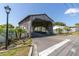 Charming covered bridge entry to The Wilds community with manicured landscaping and a community sign at 6219 Wilds Dr # 11A, New Port Richey, FL 34653