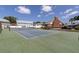 Well-maintained tennis court with green and blue surface, perfect for recreational play within the community at 6219 Wilds Dr # 11A, New Port Richey, FL 34653
