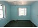 Bright bedroom features two windows that provide natural light to the blue walls and a ceiling fan at 6327 Skyline Ct, Spring Hill, FL 34606