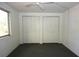 This bedroom features dual closets and a window at 6327 Skyline Ct, Spring Hill, FL 34606