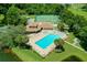 Aerial view of community featuring a pool, jacuzzi, clubhouse, and tennis courts at 6338 Spring Flower Dr # 15, New Port Richey, FL 34653