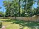 Large backyard features a wood fence and plenty of space for outdoor activities and relaxation at 6338 Spring Flower Dr # 15, New Port Richey, FL 34653
