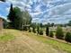 Spacious backyard with fence, green lawn, and mature trees providing shade and privacy at 6338 Spring Flower Dr # 15, New Port Richey, FL 34653
