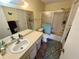 Bathroom with shower-tub combo and classic vanity, providing comfort and functionality at 6338 Spring Flower Dr # 15, New Port Richey, FL 34653