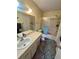Bathroom with shower-tub combo and classic vanity, providing comfort and functionality at 6338 Spring Flower Dr # 15, New Port Richey, FL 34653
