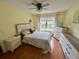 Comfortable bedroom with ceiling fan, hardwood floors and sunny window at 6338 Spring Flower Dr # 15, New Port Richey, FL 34653