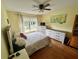 Bright bedroom features a ceiling fan and natural light, creating a cozy retreat at 6338 Spring Flower Dr # 15, New Port Richey, FL 34653