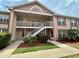 Charming condo exterior with well-maintained landscaping and a welcoming staircase at 6338 Spring Flower Dr # 15, New Port Richey, FL 34653