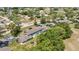 Aerial view of condominium community with lush landscaping, mature trees, and proximity to the lake at 7644 St Andrews Blvd # 0, Weeki Wachee, FL 34613