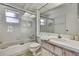 Clean bathroom featuring shower over tub, white tile and sliding shower door at 7644 St Andrews Blvd # 0, Weeki Wachee, FL 34613