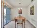 Cozy dining area with modern chandelier and sliding door access to a balcony at 7644 St Andrews Blvd # 0, Weeki Wachee, FL 34613
