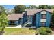 A charming exterior view of townhomes with lush landscaping and bright blue facade at 7644 St Andrews Blvd # 0, Weeki Wachee, FL 34613