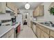 Functional kitchen featuring light wood cabinets, basic appliances and a bright ambiance at 7644 St Andrews Blvd # 0, Weeki Wachee, FL 34613