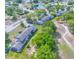 An aerial view showcases the well-maintained property with lush landscaping and ample parking at 7662 St Andrews Blvd, Weeki Wachee, FL 34613