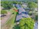 Aerial view of blue apartments, surrounded by tall green trees and lush green lawns at 7662 St Andrews Blvd, Weeki Wachee, FL 34613