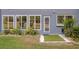 Charming backyard featuring artificial turf, garden bed, and access door at 7662 St Andrews Blvd, Weeki Wachee, FL 34613