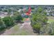 An aerial shot showcases the building with its well-maintained lawn and lush greenery at 7662 St Andrews Blvd, Weeki Wachee, FL 34613