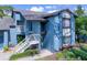 Inviting condo with a blue exterior and a well-manicured lawn at 7662 St Andrews Blvd, Weeki Wachee, FL 34613