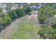 Aerial view of a well-maintained lawn with a golf cart parked on the lush greenery, perfect for outdoor activities at 7662 St Andrews Blvd, Weeki Wachee, FL 34613