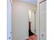 Hallway with white doors and trim reveals a glimpse of the black and white tiled bathroom at 7662 St Andrews Blvd, Weeki Wachee, FL 34613