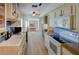 Bright kitchen with light cabinets, stone countertops, tile backsplash, wood flooring, and stainless appliances at 7662 St Andrews Blvd, Weeki Wachee, FL 34613