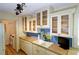 Kitchen features sleek white cabinets, complementing countertops, and modern fixtures at 7662 St Andrews Blvd, Weeki Wachee, FL 34613