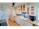 Kitchen boasts white cabinetry, sleek countertops, stainless appliances, and hardwood floors at 7662 St Andrews Blvd, Weeki Wachee, FL 34613