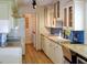 Charming kitchen with white cabinetry, light countertops, stainless appliances, and wood flooring at 7662 St Andrews Blvd, Weeki Wachee, FL 34613