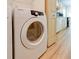 Bright laundry room with Samsung washer/dryer and wooden floors adds convenience and style at 7662 St Andrews Blvd, Weeki Wachee, FL 34613