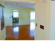 Open-concept living room with laminate flooring, neutral walls, and ample natural light at 7662 St Andrews Blvd, Weeki Wachee, FL 34613