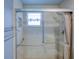Shower with grab bars, seating, and shower curtain inside the glass door at 7662 St Andrews Blvd, Weeki Wachee, FL 34613